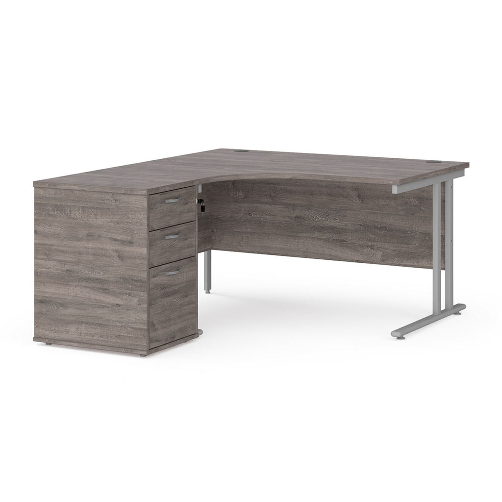 Picture of Maestro 25 left hand ergonomic desk 1400mm with silver cantilever frame and desk high pedestal - grey oak