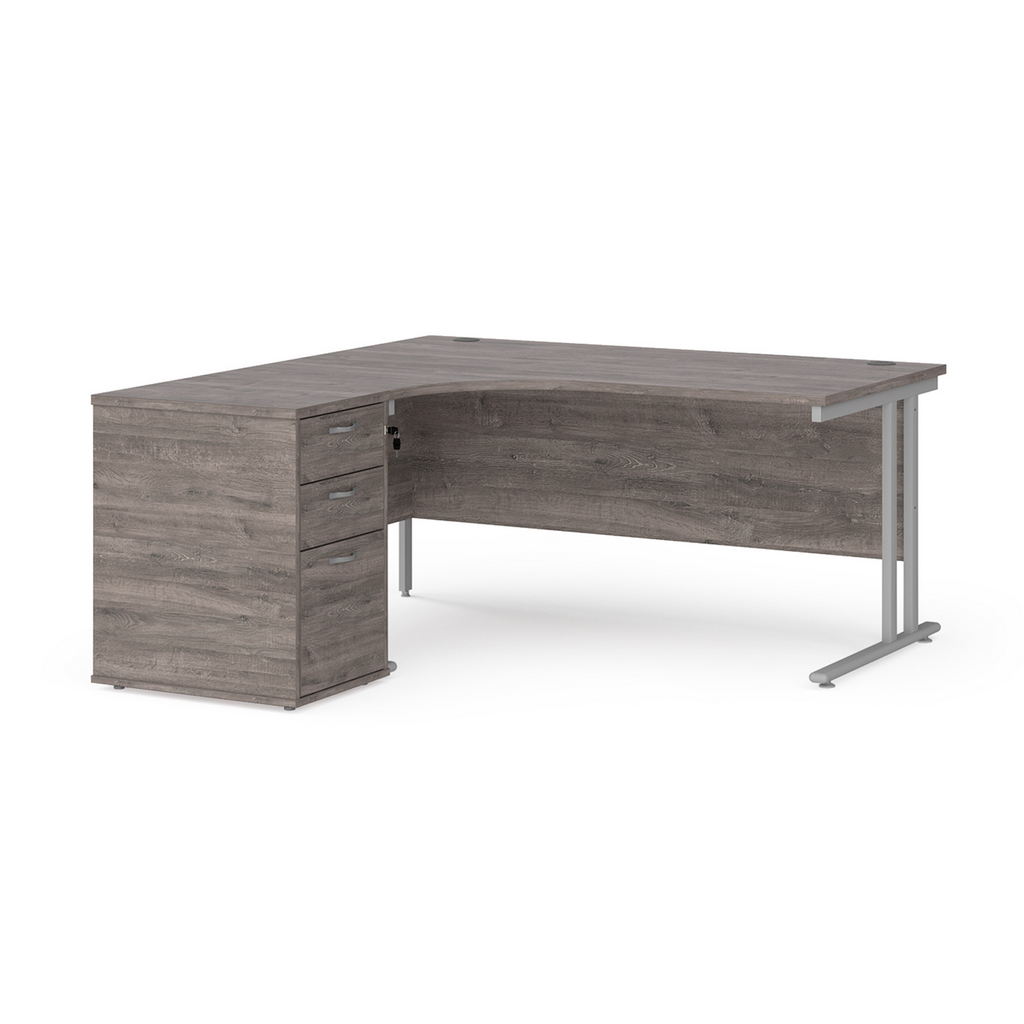 Picture of Maestro 25 left hand ergonomic desk 1600mm with silver cantilever frame and desk high pedestal - grey oak