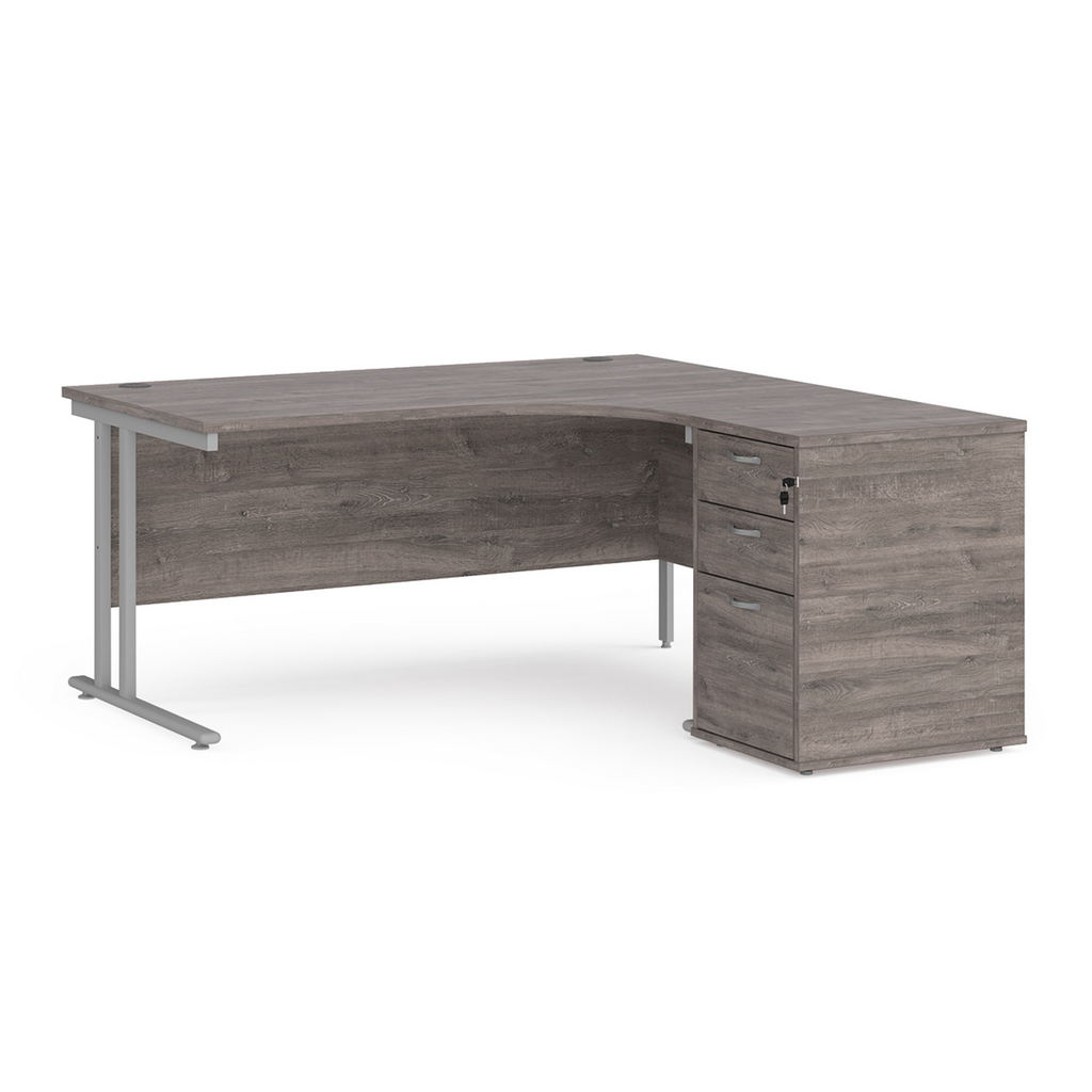 Picture of Maestro 25 right hand ergonomic desk 1600mm with silver cantilever frame and desk high pedestal - grey oak
