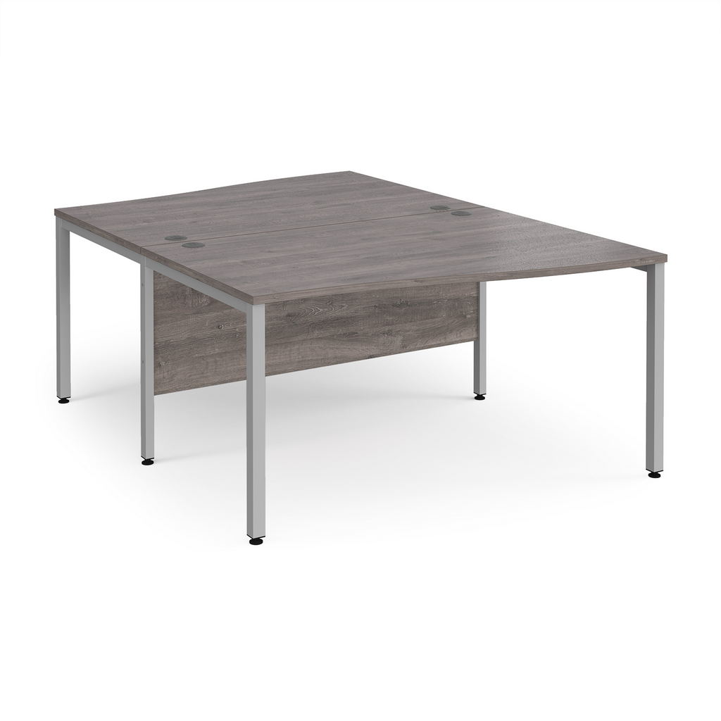 Picture of Maestro 25 back to back wave desks 1400mm deep - silver bench leg frame, grey oak top